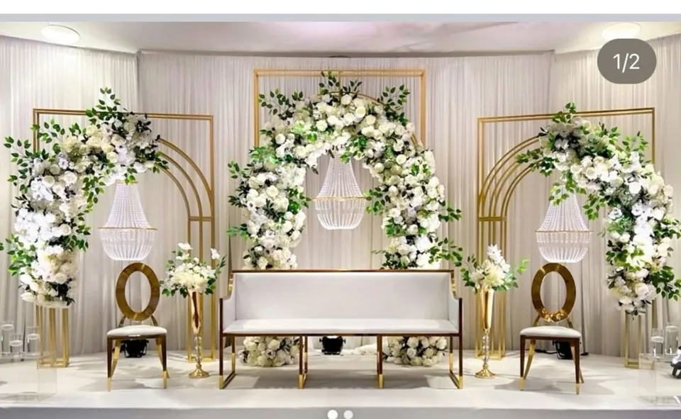 Gold hoop arches with white blooms and elegant seating