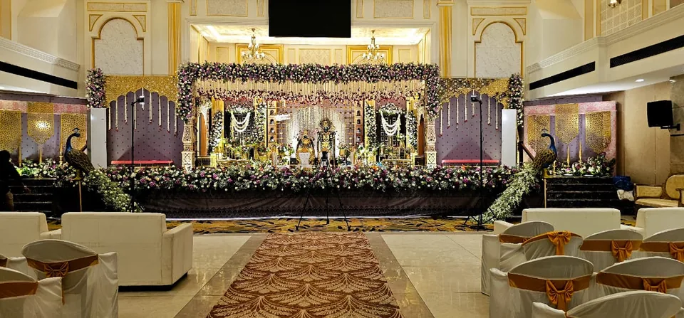 Heritage hall stage with gold pillars and classic floral borders