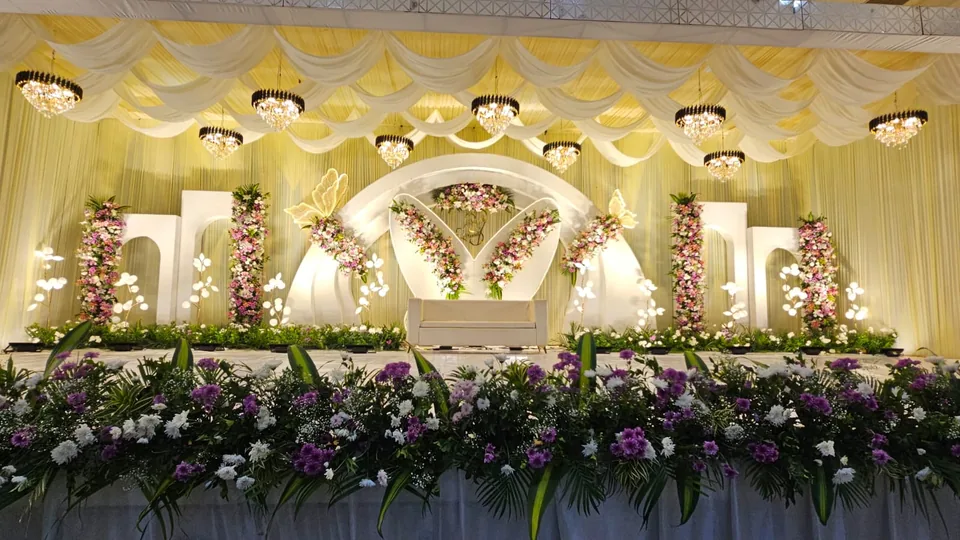 Pastel wedding stage with twin floral wings and soft canopy