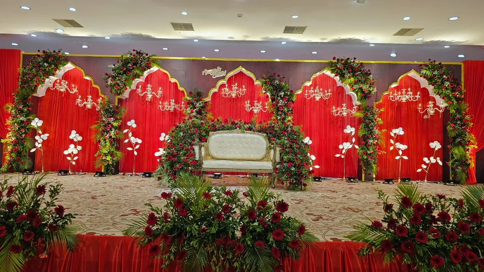 Grand red and white themed stage with rose arches