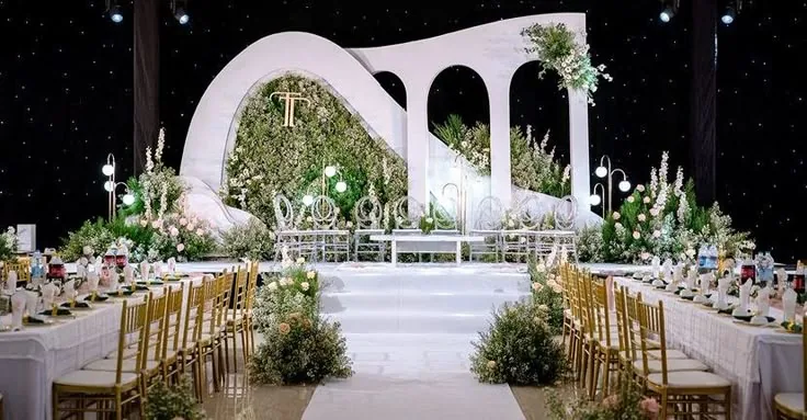 Starlit ballroom reception with white arch stage and banquet tables