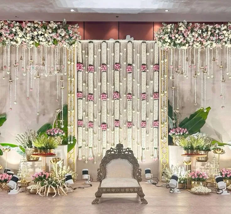 Traditional stage with carved seat, floral strands and banana accents